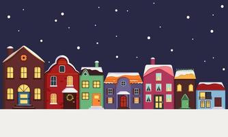 calle de la ciudad de casas multicolores brillantes con techo cubierto de nieve, luz en las ventanas y copos de nieve en el fondo. felices decoraciones navideñas para año nuevo y navidad. invierno y elementos festivos vector