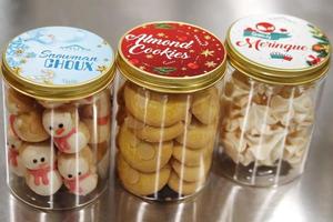 a jar of christmas cookies in the shape of a snowman photo