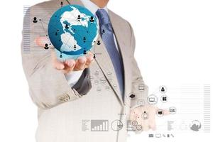 businessman hand holds the earth and social network diagram photo