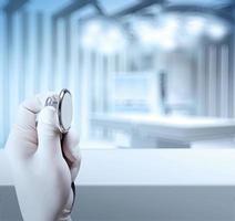 a stethoscope in the hands and Empty table and blurred background for medical product presentation photo