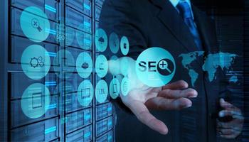 Double exposure of businessman hand showing search engine optimization SEO as concept photo