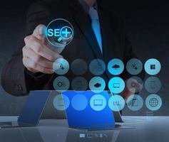 businessman hand showing search engine optimization SEO photo