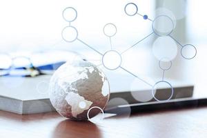 hand drawn texture globe with blank social media diagram on wood table near note book and glasses photo