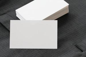 Blank corporate identity package business card with dark grey suit background. photo