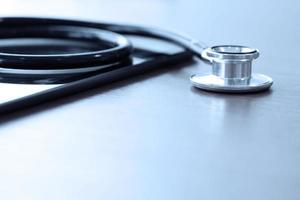 Studio macro of a stethoscope and digital tablet with shallow DOF evenly matched abstract on wood table background copy space photo