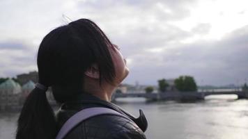 gros plan femme asiatique debout et voyant une belle vue sur la rivière en suède, prendre une profonde respiration et prendre de l'air frais, voyager à l'étranger en vacances, fond de rivière video