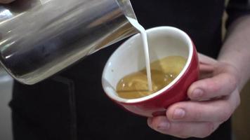 barman bereidt kopje koffie cappuccino met melk in een café-bar video