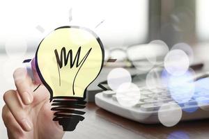 hand drawing creative business strategy with light bulb as concept photo