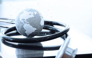 Studio macro of a stethoscope and texture globe with digital tablet with shallow DOF evenly matched abstract as medical network concept photo