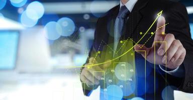 Double exposure of businessman hand working with new modern computer and business strategy as concept photo