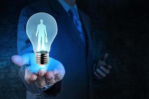 businessman with  light bulb  choosing people icon as human resources concept photo