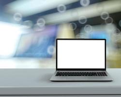 Laptop with blank screen on white desk with blurred background as concept photo