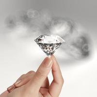 hand holding 3d diamond over grey background photo