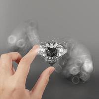 hand holding 3d diamond over grey background photo