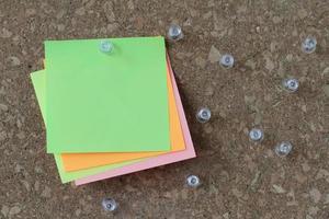 pin board and blank sticky note on cork board as concept photo