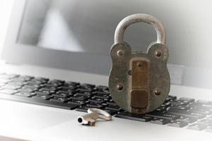 Internet security concept-old padlock and key on laptop computer keyboard photo