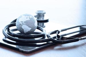 Studio macro of a stethoscope and texture globe with digital tablet with shallow DOF evenly matched abstract as medical network concept photo