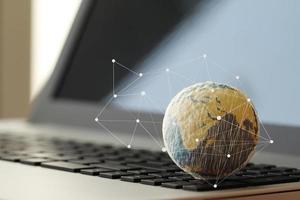 hand drawn texture globe on laptop computer as internet concept photo