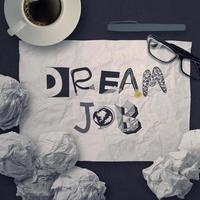 hand drawn design words DREAM JOB on crumpled paper background as concept photo