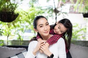 The daughter is hugging her mother and laughing happy photo