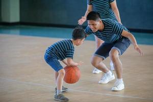 Asian family playing basketball together. Happy family spending free time together on holiday photo