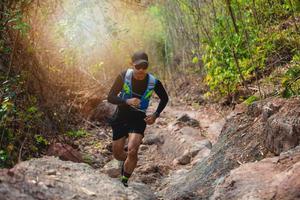 A man Runner of Trail . and athlete's feet wearing sports shoes for trail running in the forest