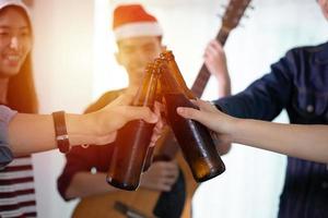 Asian group of friends having party with alcoholic beer drinks and Young people enjoying at a bar toasting cocktails photo