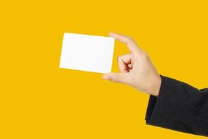 businesswoman asian holding and shown a business card on yellow background photo