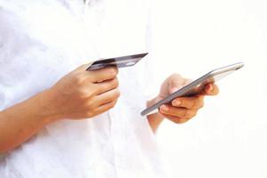 woman asian using smartphone and credit card shopping online , selective focus on hand photo