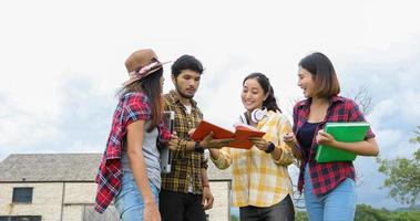 Group Students Smile and have fun It also helps to share ideas in the work and project. And also review the book before the exam outdoor in the garden. photo