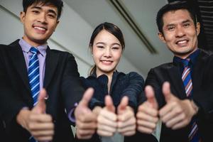 smiling happy Businessman and Businesswomen celebrating success Achievement Arm Raised and show thumb up Concept photo