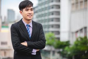 Happy handsome businessman standing and smiling  at outdoor photo