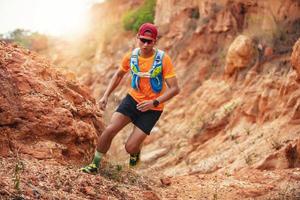 A man Runner of Trail . and athlete's feet wearing sports shoes for trail running in the mountains photo