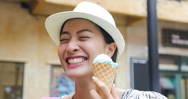 Beautiful female holding and eating ice cream on summer holidays photo