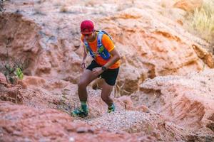 A man Runner of Trail . and athlete's feet wearing sports shoes for trail running in the mountains photo
