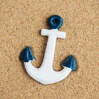 Decorative anchor on a sand photo