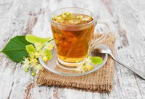 cup of herbal tea with linden flowers photo