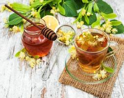 cup of herbal tea with linden flowers photo