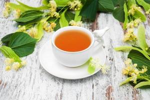 cup of herbal tea with linden flowers photo