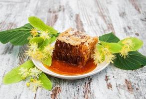 Honeycomb and linden flowers photo