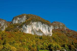 Cornalba crag among the colorful trees in autumn photo