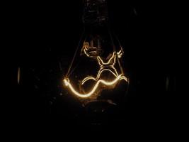 Tungsten filament wire of incandescent light bulb photo