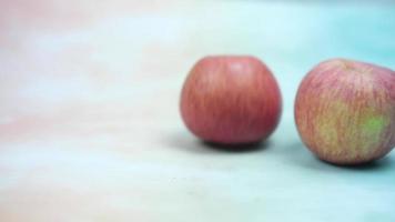 One of rolling red apples