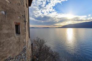 Sunset from the church of Santa Caterina del Sasso. It is a monastery built in 1170, overlooking the eastern shore of Lake Maggiore, in the municipality of Leggiuno, Northern Italy. photo