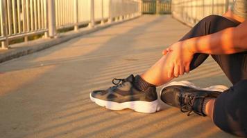 woman doing leg massage on footbridge video