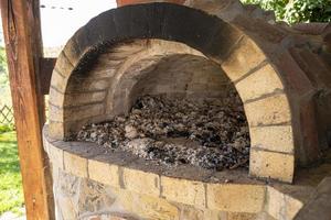 Burning firewood in a furnace, embers, glowing coals. photo