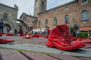 Bergamo Itali 17 May 2013 Red shoes to denounce violence against women photo