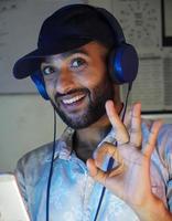 a young man with headphones listning music and enjoying photo