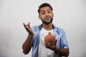 Man Showing his piggy bank indian piggy bank selective focus image saving money for education photo