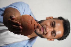 A boy Showing his piggy bank indian piggy bank selective focus image saving money for education photo